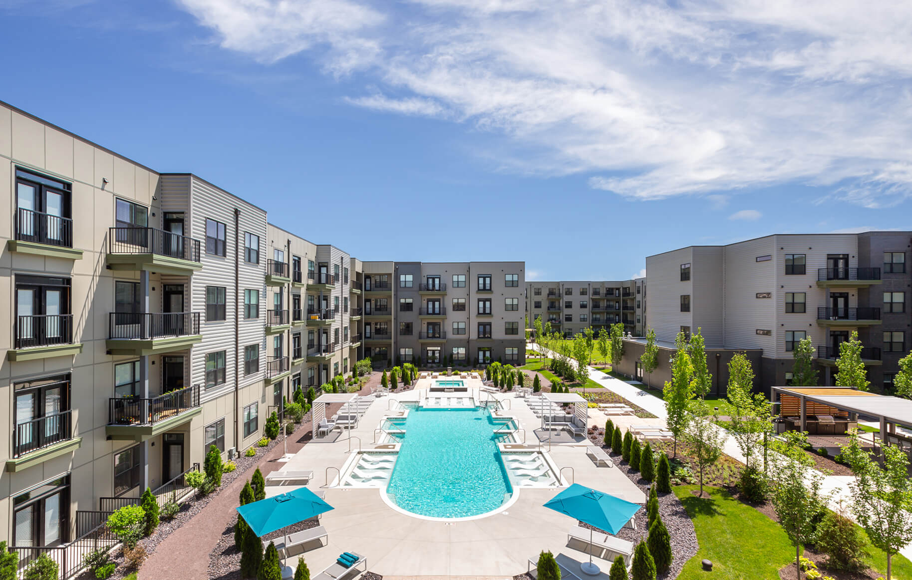 large swimming pool in the courtyard of apartment buildings